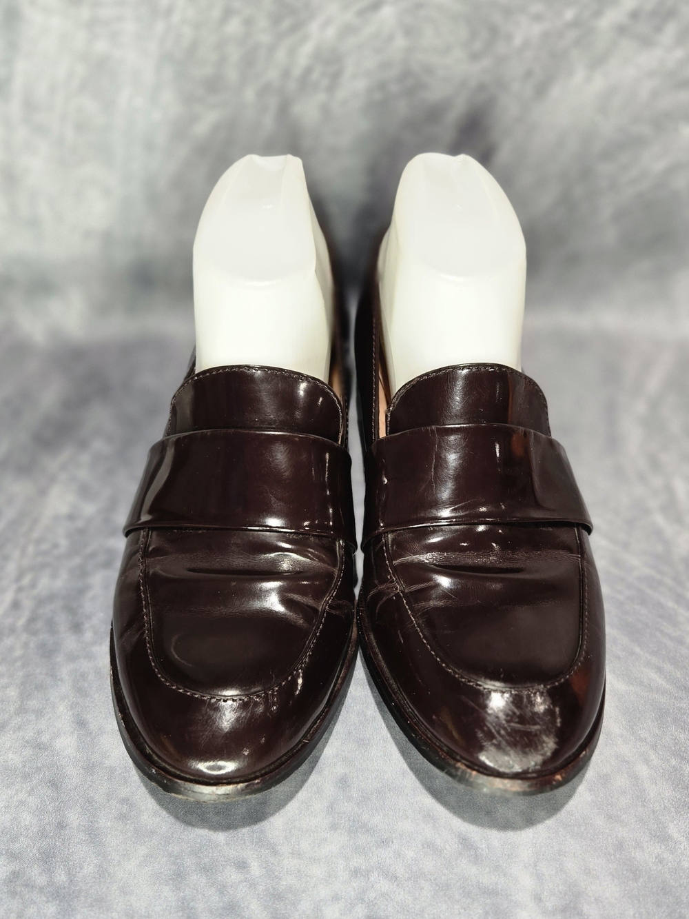 Madewell Elin Penny Loafers in a glossy burgundy patent leather finish.